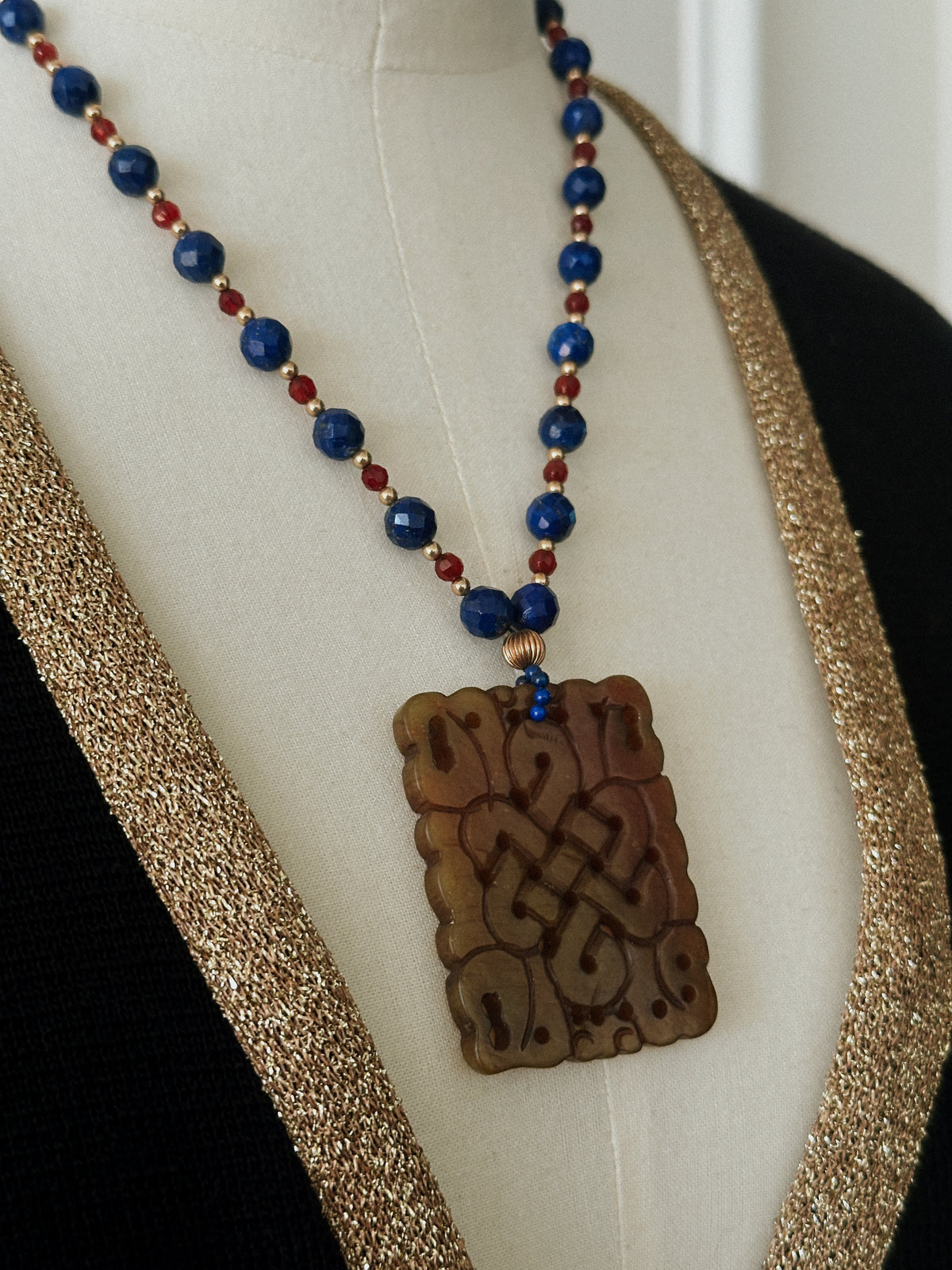 Faceted Gemstone Necklace with Carved Hardstone Pendant