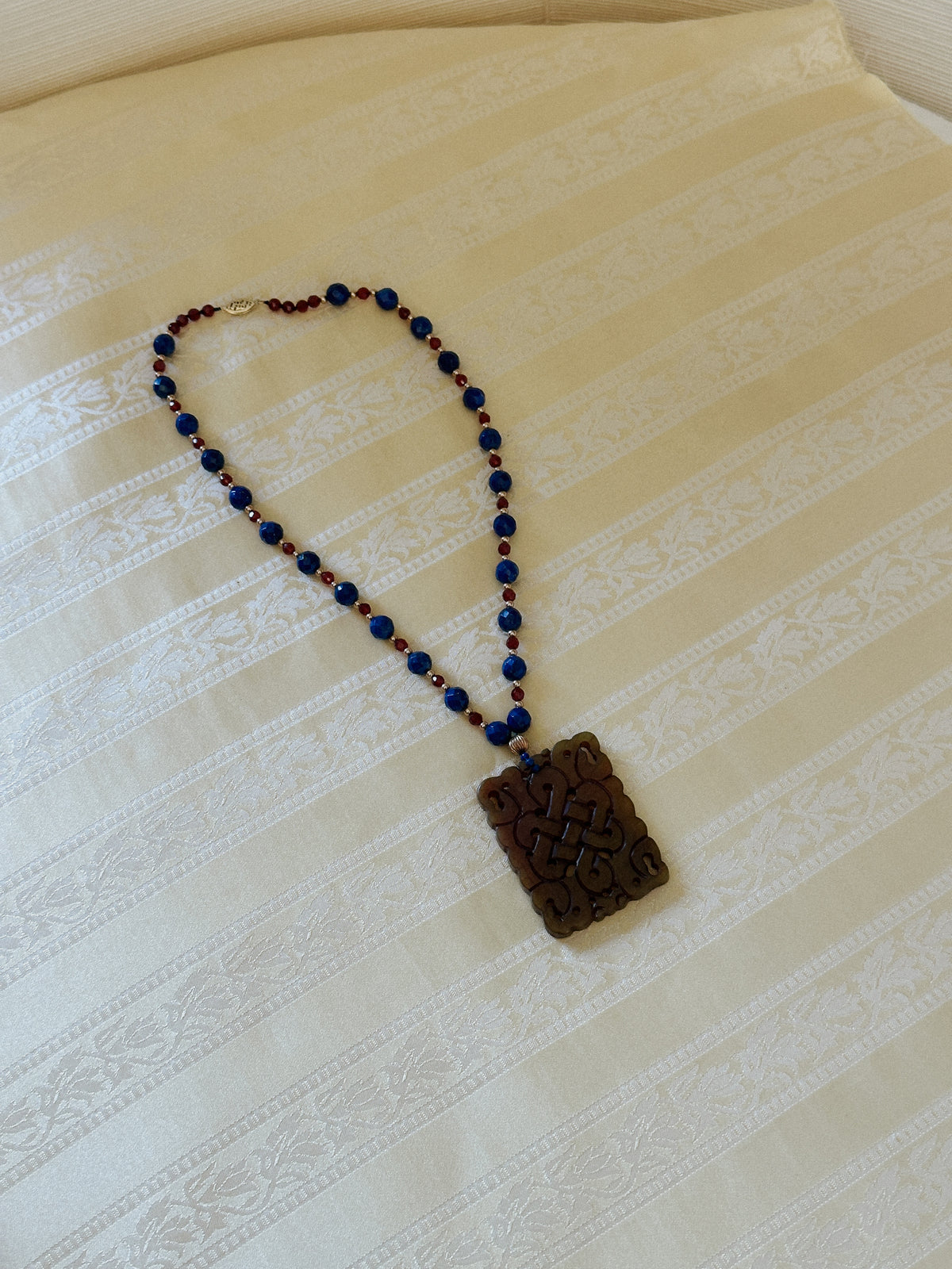 Faceted Gemstone Necklace with Carved Hardstone Pendant