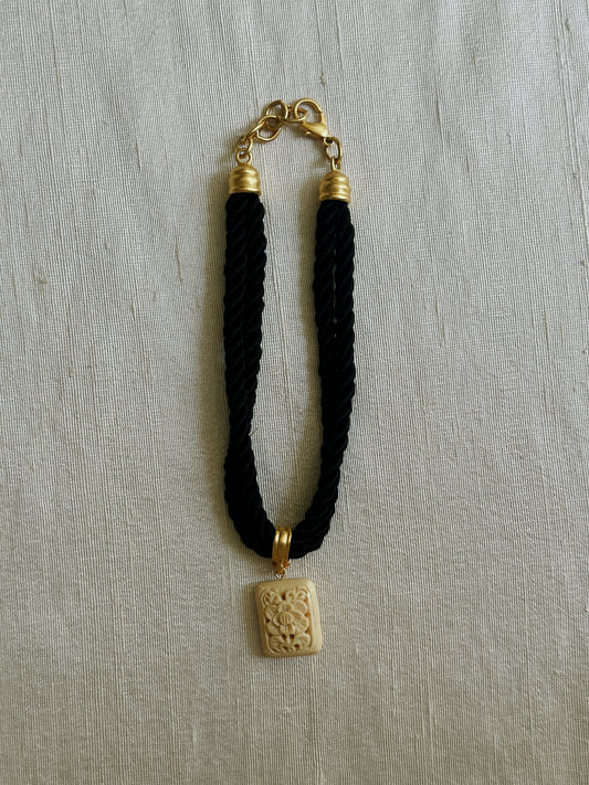 Black Rope Necklace with Carved Ivory Tone Pendant