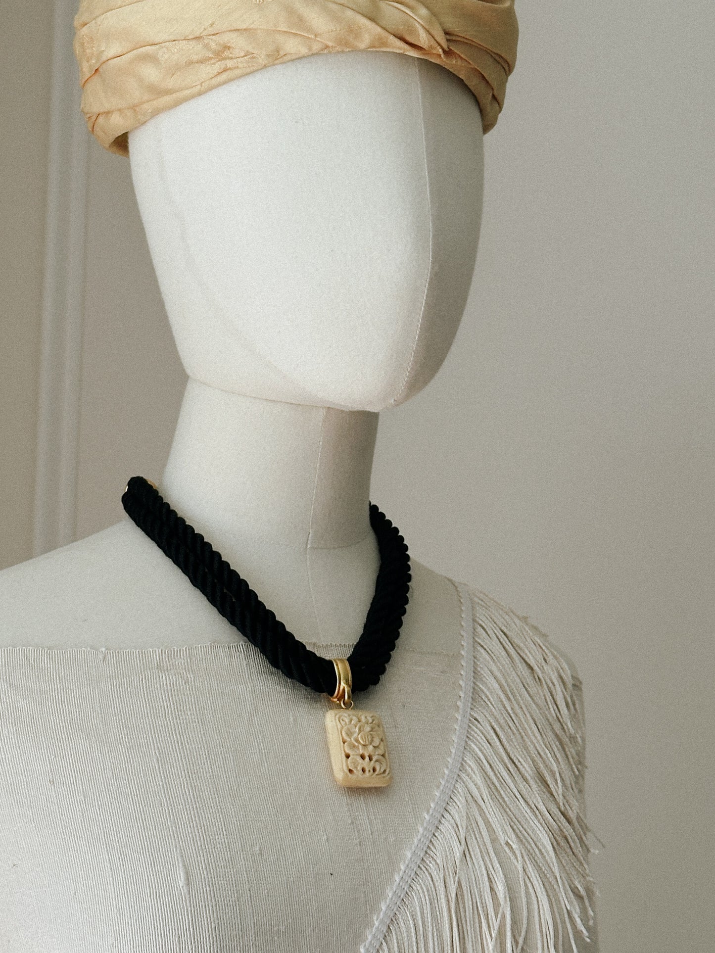 Black Rope Necklace with Carved Ivory Tone Pendant